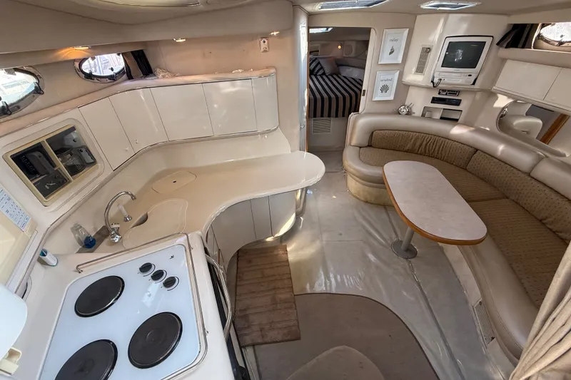Slide: The Image of Interior of a 1996 Sea Ray Sundancer 370 yacht with kitchen and seating area. - 33