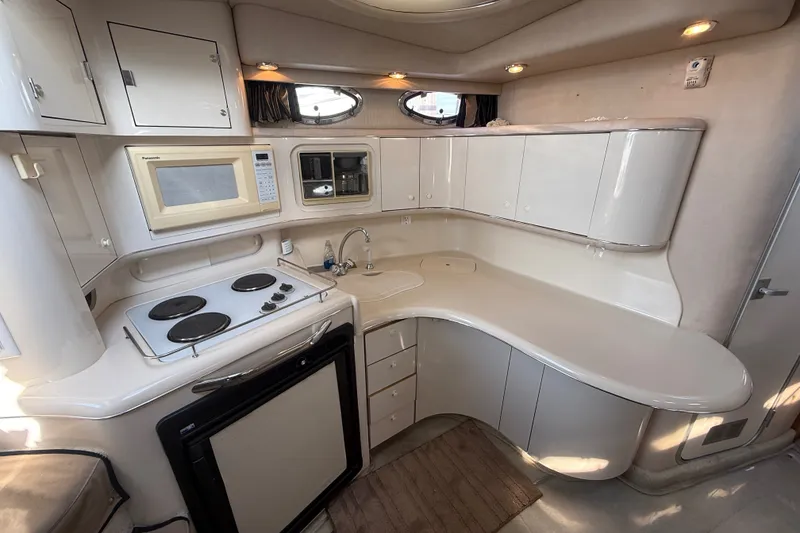 Slide: The Image of Interior of 1996 Sea Ray Sundancer 370 yacht kitchen with stove, microwave, and cabinets. - 35