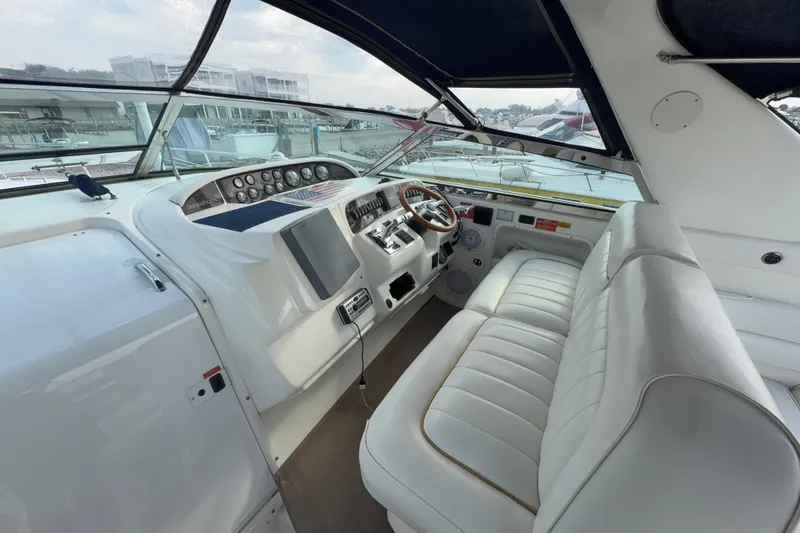 Slide: The Image of 1996 Sea Ray Sundancer 370 helm with white seating and control panel. - 17