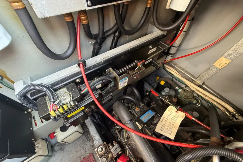 Slide: The Image of Engine compartment of a 1996 Sea Ray Sundancer 370 with visible wiring and components. - 70