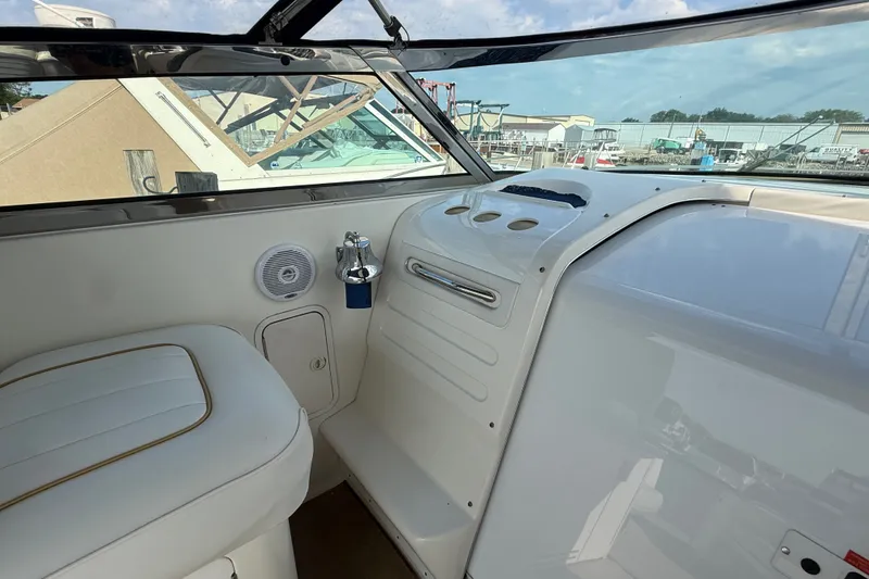 Slide: The Image of Interior view of a 1996 Sea Ray Sundancer 370 boat cockpit with white seating. - 30