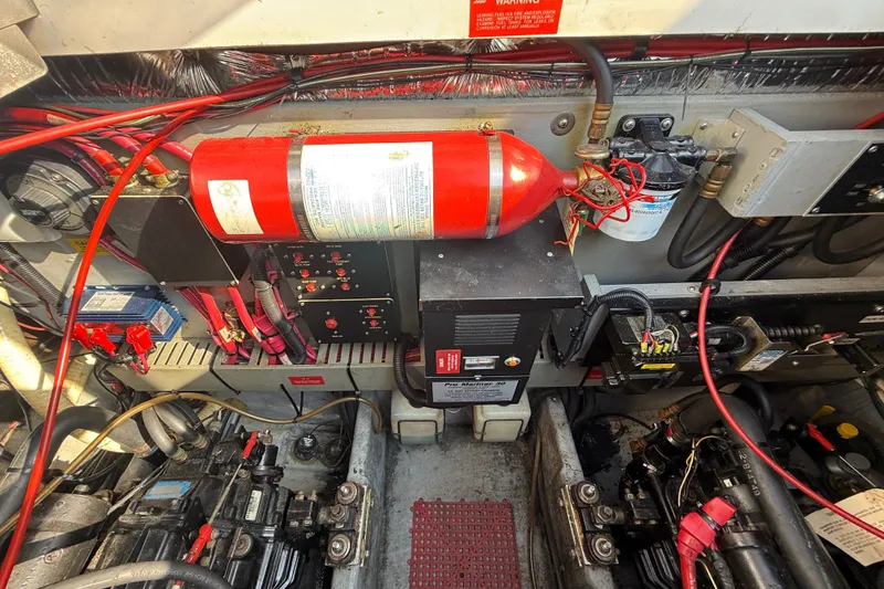 Slide: The Image of Engine compartment of a 1996 Sea Ray Sundancer 370 with fire extinguisher and electrical components. - 64