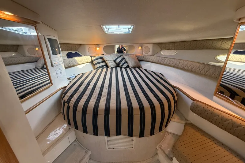 Slide: The Image of Luxurious cabin interior of 1996 Sea Ray Sundancer 370 yacht with striped bedding. - 52