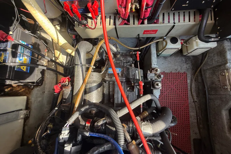 Slide: The Image of Engine compartment of a 1996 Sea Ray Sundancer 370 with visible wiring and components. - 65