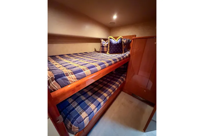 Slide: The Image of Bunk beds with plaid bedding in 2003 Viking 48 Convertible yacht cabin. - 22