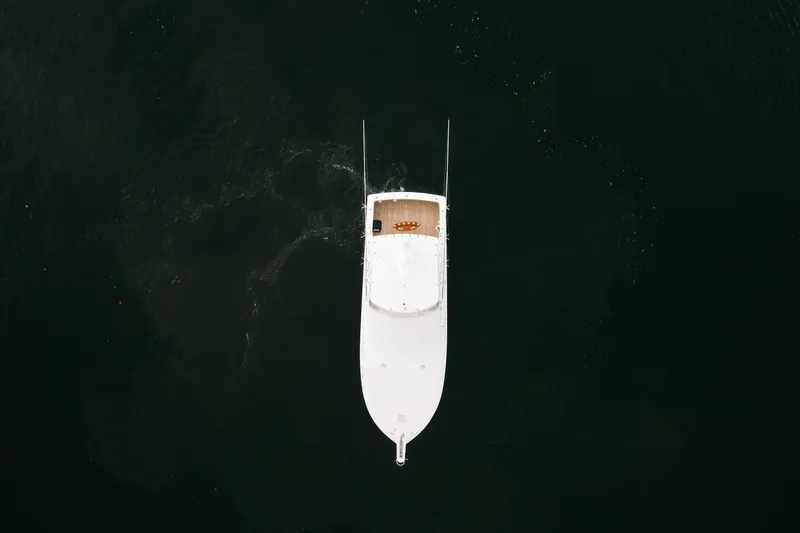 Slide: The Image of Aerial view of a 2003 Viking 48 Convertible yacht on dark water. - 13