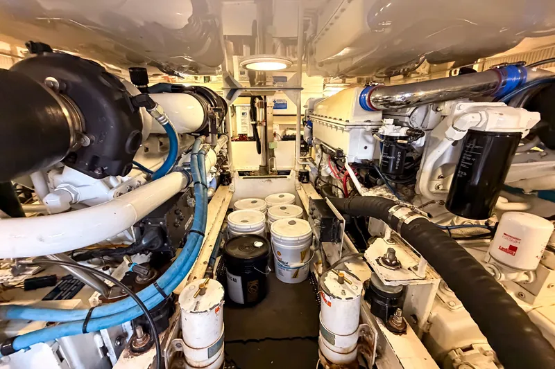 Slide: The Image of Engine room of a 2003 Viking 48 Convertible yacht, showcasing machinery and components. - 30