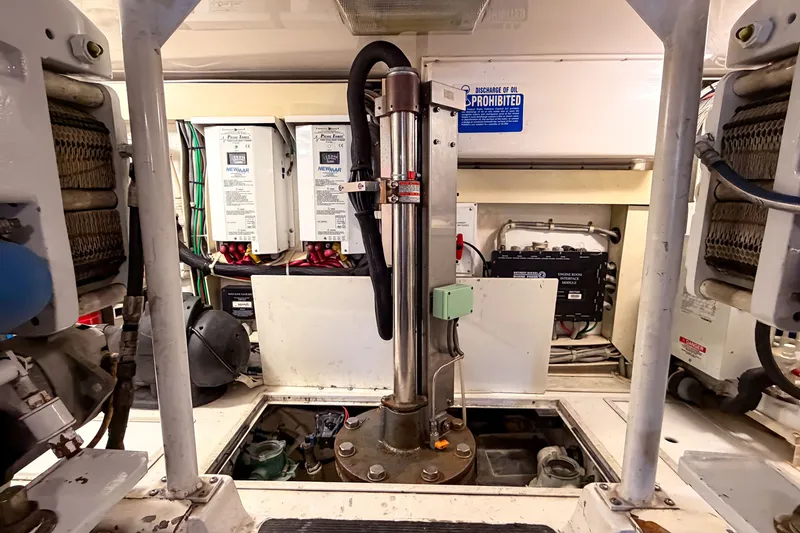 Slide: The Image of Engine room of 2003 Viking 48 Convertible yacht, showcasing mechanical components and equipment. - 33