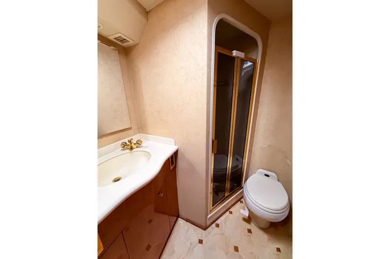 Slide: The Image of Bathroom interior of 2003 Viking 48 Convertible yacht with shower, sink, and toilet. - 23