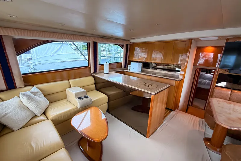 Slide: The Image of Luxurious interior of a 2003 Viking 48 Convertible yacht with plush seating and elegant wood finishes. - 14