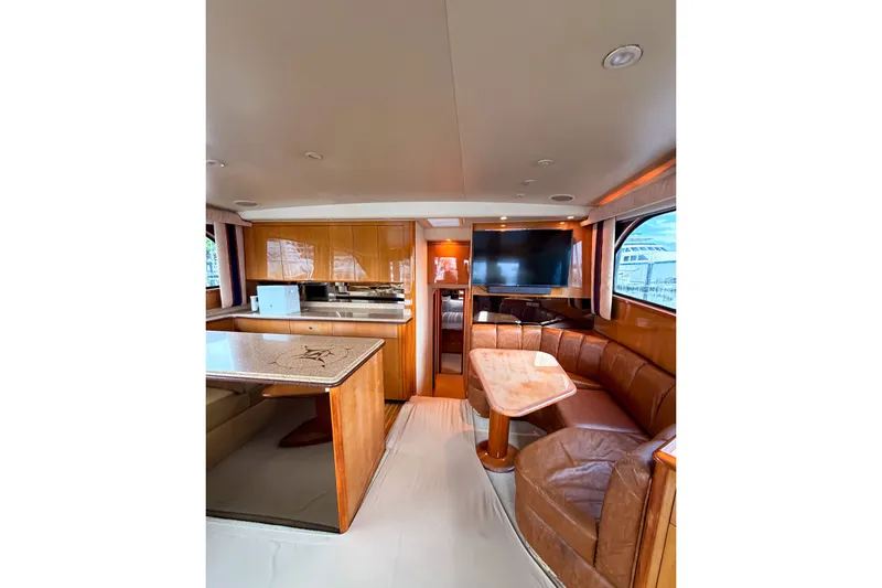 Slide: The Image of Luxurious interior of a 2003 Viking 48 Convertible yacht with leather seating and modern amenities. - 16