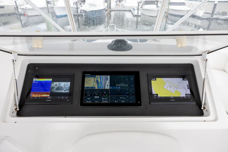 Slide: The Image of Helm of 2003 Viking 48 Convertible with advanced navigation displays. - 27