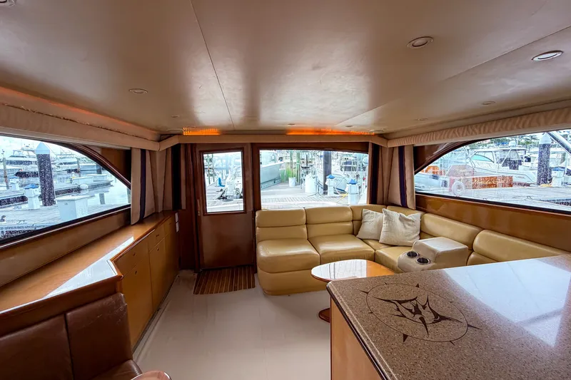 Slide: The Image of Luxurious interior of a 2003 Viking 48 Convertible yacht with leather seating and large windows. - 17