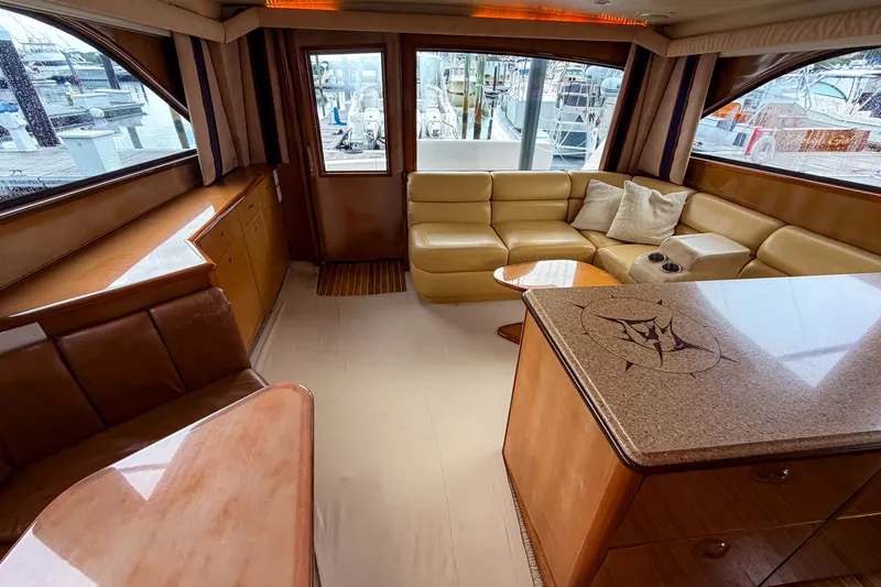Slide: The Image of Luxurious interior of a 2003 Viking 48 Convertible yacht with leather seating and elegant wood finishes. - 18