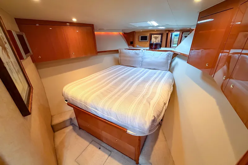 Slide: The Image of Luxurious cabin interior of 2003 Viking 48 Convertible yacht with cozy bed and wooden cabinetry. - 19