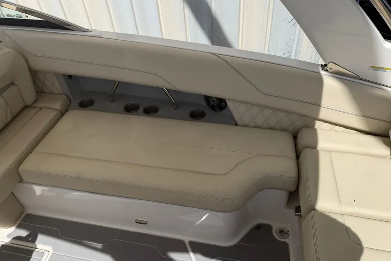Slide: The Image of 2019 Regal LS6 boat interior with beige leather seating and cup holders. - 16