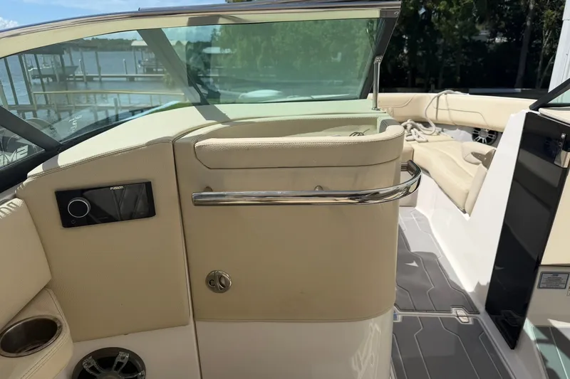 Slide: The Image of Interior of a 2019 Regal LS6 boat with beige seating and audio controls. - 14