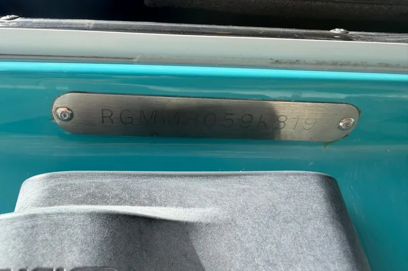 Slide: The Image of 2019 Regal LS6 boat hull identification number plate, RGMMH059K819, on a blue surface. - 20