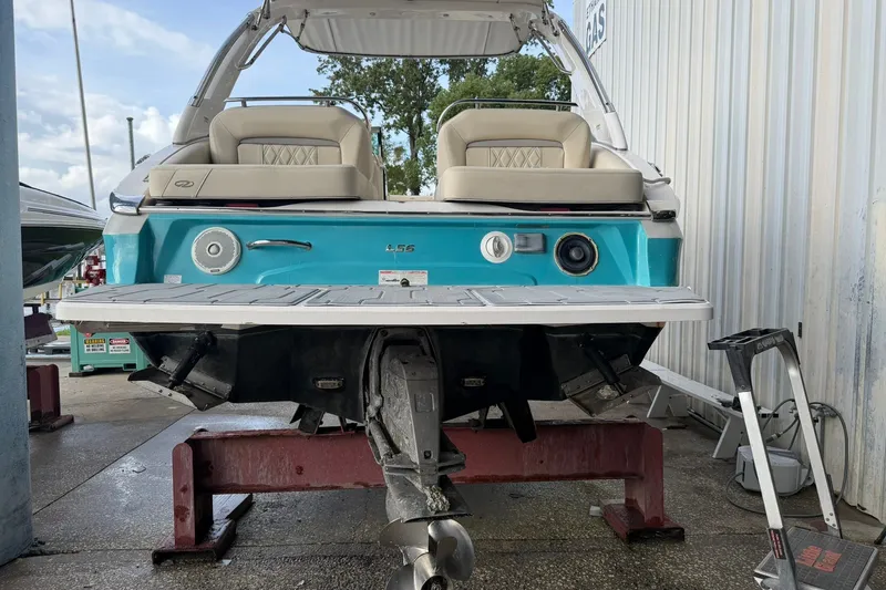 Slide: The Image of 2019 Regal LS6 boat on stand, showcasing rear view and seating. - 19