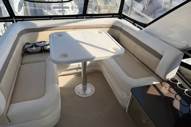 Slide: The Image of Luxurious seating area on 2012 Sea Ray 450 Sedan Bridge yacht with table and cushions. - 55