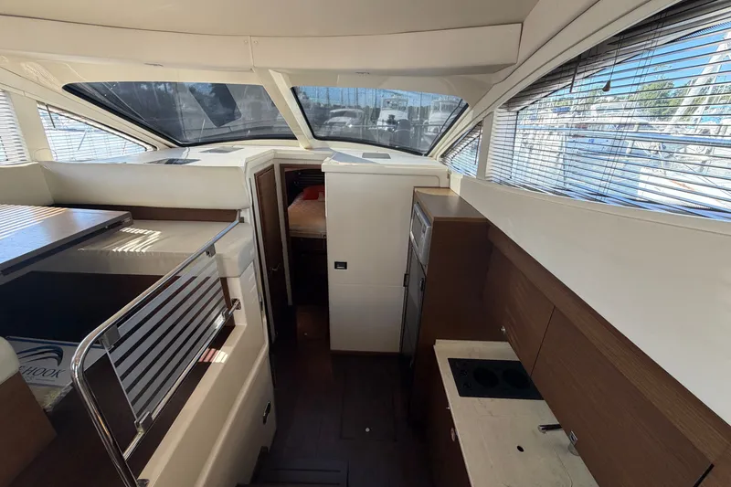 Slide: The Image of Interior of 2012 Sea Ray 450 Sedan Bridge yacht, featuring modern kitchen and seating area. - 26