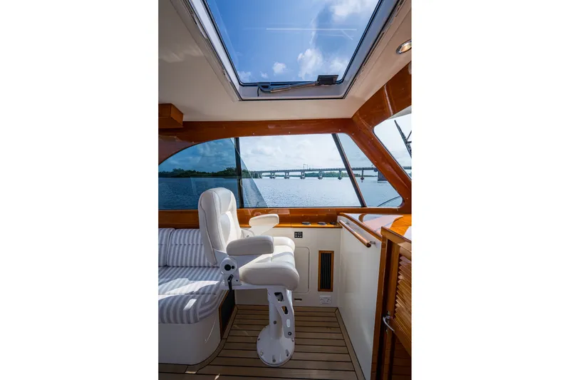 Slide: The Image of Interior of 2022 Hinckley Picnic Boat 40 with scenic water view through window. - 10
