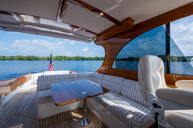 Slide: The Image of Luxurious 2022 Hinckley Picnic Boat 40 interior with elegant seating and scenic water view. - 9