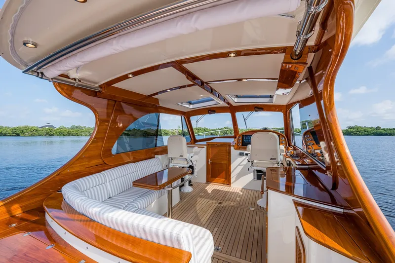 Slide: The Image of Luxurious 2022 Hinckley Picnic Boat 40 interior with elegant wood finish and spacious seating. - 7