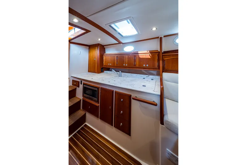 Slide: The Image of Luxurious interior of 2022 Hinckley Picnic Boat 40 with elegant wood cabinetry and modern amenities. - 13