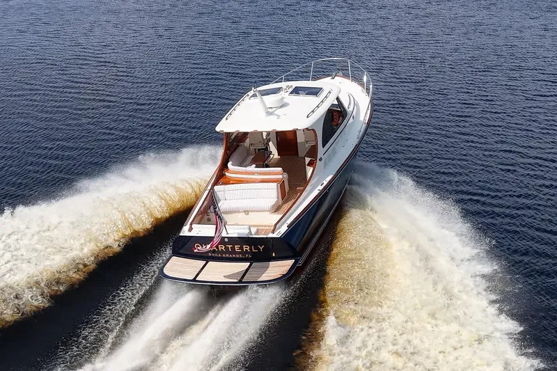 Slide: The Image of 2022 Hinckley Picnic Boat 40 cruising on open water, rear view. - 4