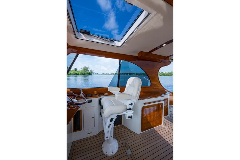 Slide: The Image of Interior of 2022 Hinckley Picnic Boat 40 with helm seat and panoramic window view. - 11