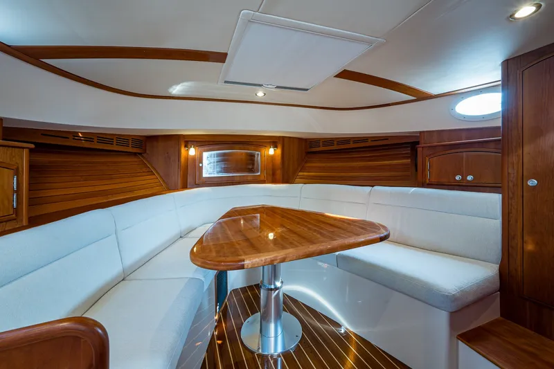 Slide: The Image of Luxurious interior of 2022 Hinckley Picnic Boat 40 with elegant wood and white seating. - 16