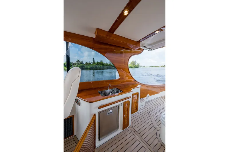 Slide: The Image of Interior of 2022 Hinckley Picnic Boat 40 with wooden finish and water view. - 8