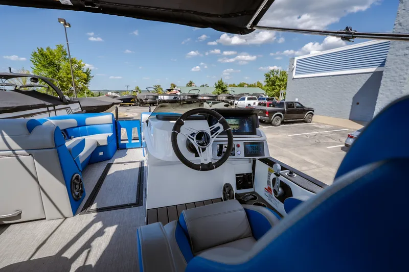 Slide: The Image of 2025 Montara 25 Surf Boss boat interior with blue seating and modern dashboard. - 43