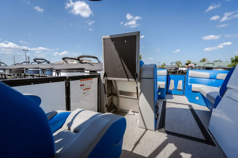 Slide: The Image of 2025 Montara 25 Surf Boss interior with blue seating under a clear sky. - 34
