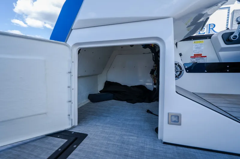 Slide: The Image of Storage compartment of 2025 Montara 25 Surf Boss boat, open door, interior view. - 28