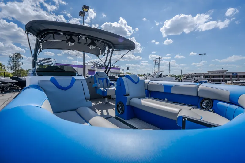 Slide: The Image of 2025 Montara 25 Surf Boss boat with blue seating under a sunny sky. - 22