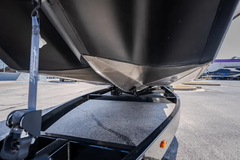 Slide: The Image of 2025 Montara 25 Surf Boss boat on trailer, showcasing hull design and trailer details. - 16