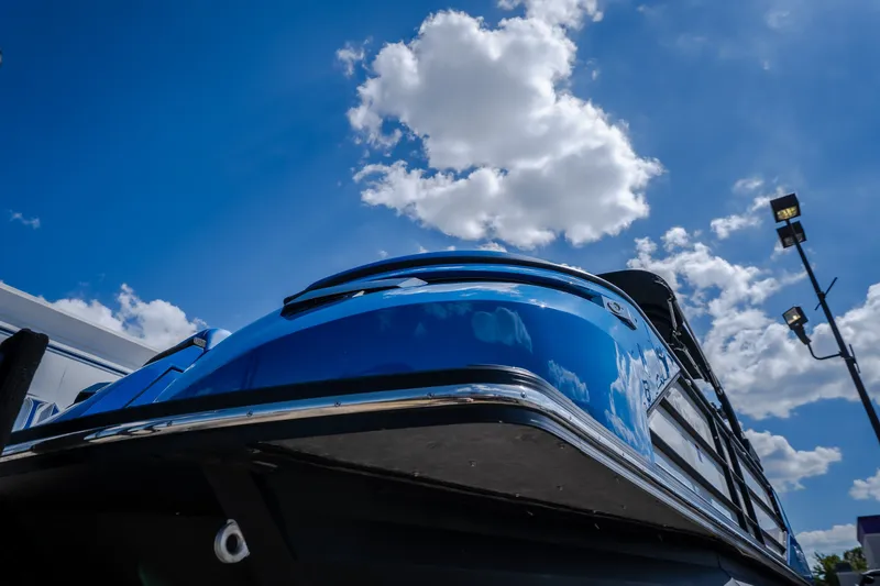 Slide: The Image of 2025 Montara 25 Surf Boss boat against a bright blue sky with clouds. - 15