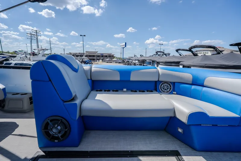 Slide: The Image of Luxurious seating on 2025 Montara 25 Surf Boss boat, featuring blue and gray upholstery. - 26
