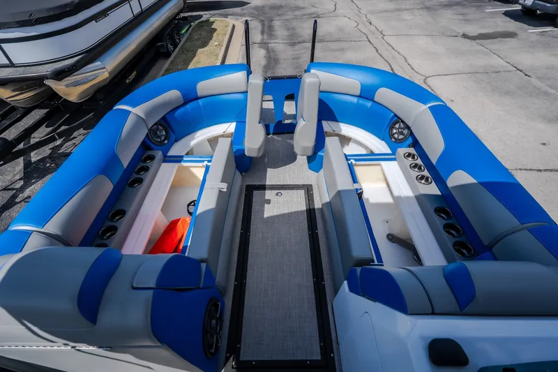 Slide: The Image of 2025 Montara 25 Surf Boss boat interior with blue seating and storage compartments. - 27