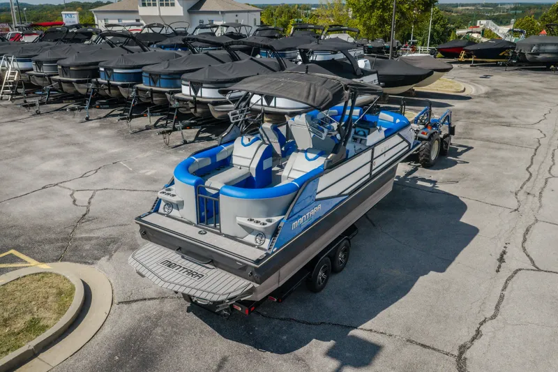 Slide: The Image of 2025 Montara 25 Surf Boss boat on trailer in dealership lot. - 8