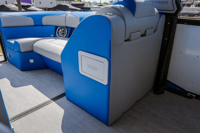 Slide: The Image of 2025 Montara 25 Surf Boss interior with blue and gray seating, featuring a built-in trash compartment. - 47
