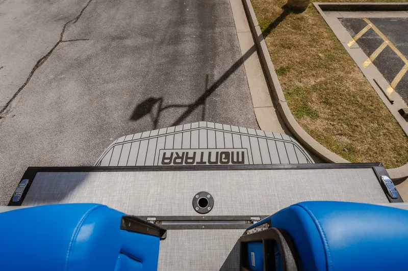 Slide: The Image of Overhead view of 2025 Montara 25 Surf Boss boat with blue seats and docked on pavement. - 37