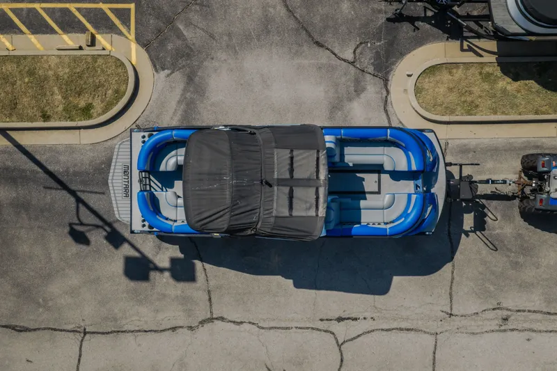 Slide: The Image of Aerial view of 2025 Montara 25 Surf Boss boat on trailer in parking lot. - 9