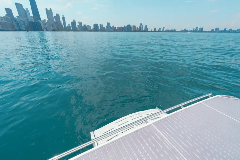 Slide: The Image of 2023 Regal LS36 boat on water with city skyline in background. - 42