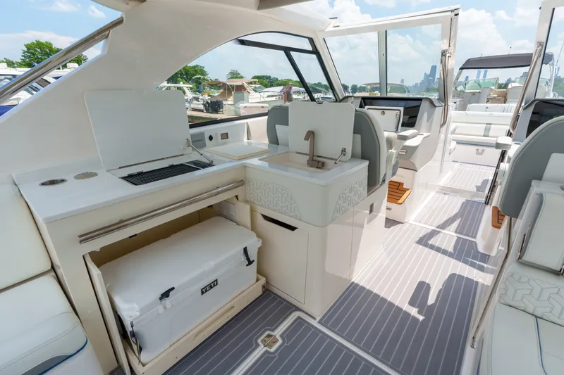 Slide: The Image of 2023 Regal LS36 luxury boat interior with kitchenette and seating area. - 37