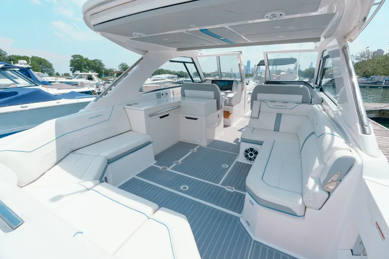 Slide: The Image of Luxurious 2023 Regal LS36 boat interior with spacious seating and modern design at a marina. - 24