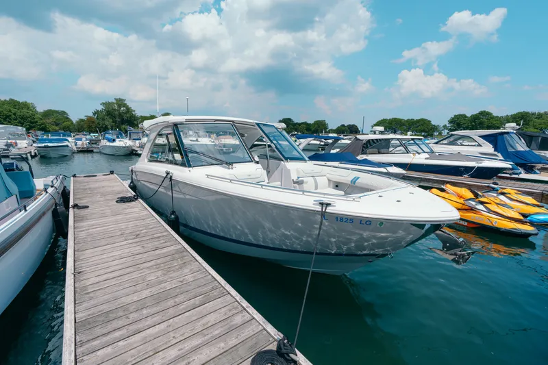 Slide: The Image of 2023 Regal LS36 boat docked at marina under blue sky. - 18