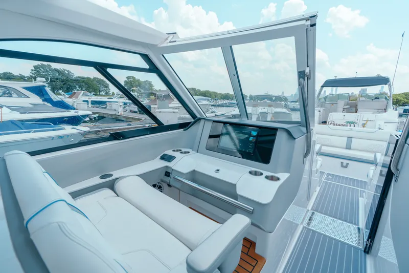 Slide: The Image of 2023 Regal LS36 yacht cockpit with modern dashboard and marina view. - 27
